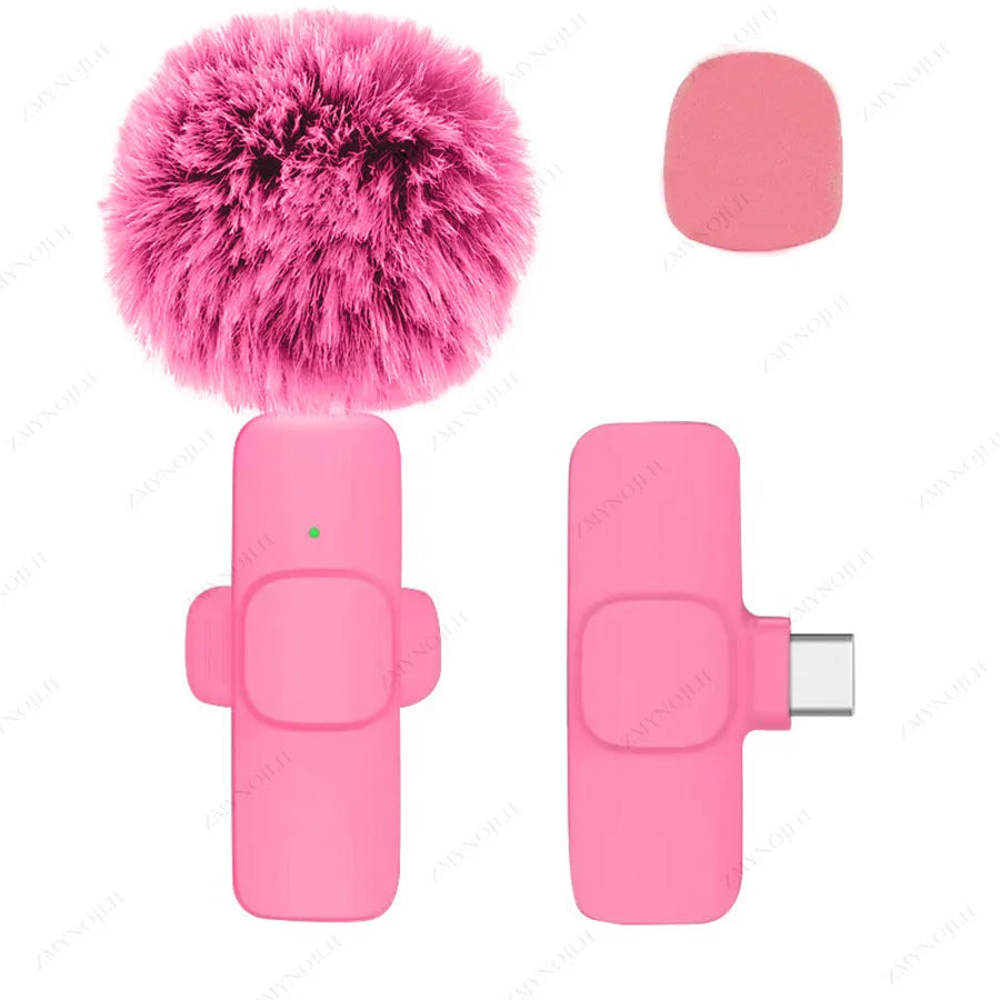 Pink microphone with fuzzy windscreen and USB adapter on a white background